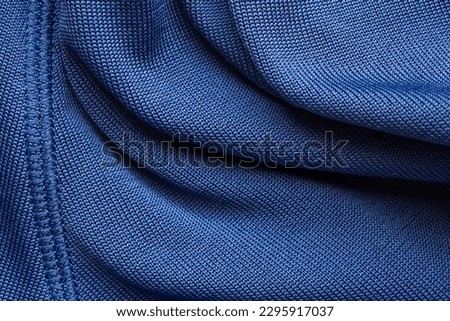 Blue sports clothing fabric football shirt jersey texture with stitches Royalty-Free Stock Photo #2295917037