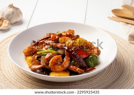 Stir fried crispy shrimp with cashew nuts and sweet pepper in white plate.Thai food not spicy. Royalty-Free Stock Photo #2295925435