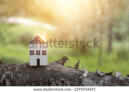 Concept image of a small house in nature. Idea of ecology, solar energy, and sustainability