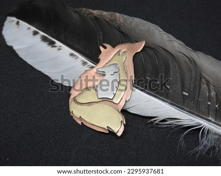 Handmade Designer Brass, Nickel and Copper Wolf Coyote Fox Broach Necklace Sculpture on a Black Background with a Black and White Accent Feather