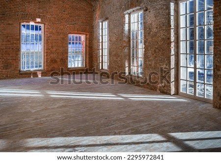 Empty interior in great studio with old brick walls and tall windows, old parquet floor. Shadow of the street lighting from window