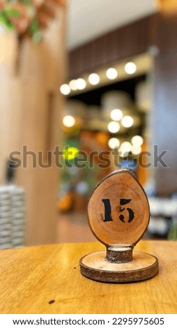 The wooden sign displaying the table number at a restaurant located in South Jakarta, Indonesia.