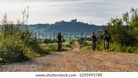 group of mountain bikers on dirt road with target in the background