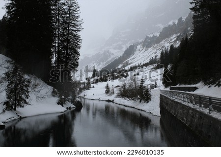 Frozen river between snowy mountains  Royalty-Free Stock Photo #2296010135
