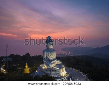 aerial view Phuket big Buddha in beautiful sunset.
the sun shines through the clouds impact on ocean surface
The beauty of the statue fits perfectly with the charming nature.
cloud scape background.
