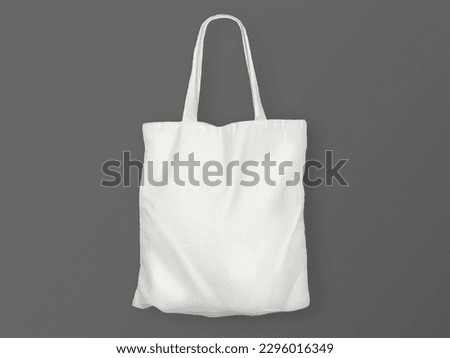 Isolated white tote bag over black surface