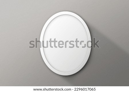 Round white frame on grey surface
