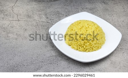 Yellow rice (nasi kuning) is a typical Indonesian food. This dish is made from rice cooked together with turmeric and coconut milk and spices Royalty-Free Stock Photo #2296029461