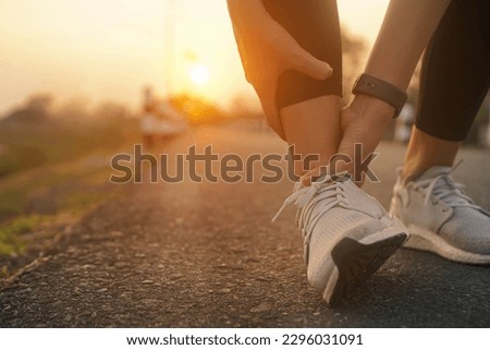 Ankle twist sprain accident in sport exercise running jogging.low key lighting. Royalty-Free Stock Photo #2296031091