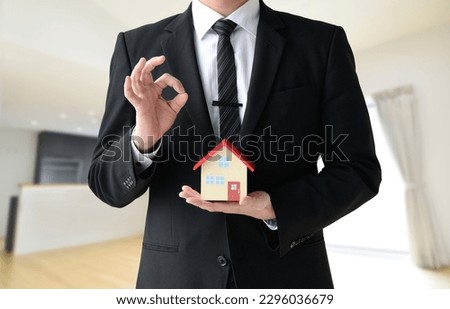 Housing sales man with OK sign