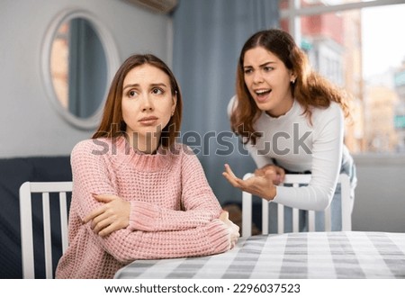 Girlfriend or sister yelling at girl during family quarrel at home Royalty-Free Stock Photo #2296037523