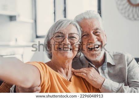 Head shot portrait happy senior couple taking selfie, having fun with phone cam, smiling aged wife and husband hugging, looking at camera, posing for photo, aged man vlogger recording video