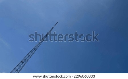 Telecommunication tower against the background of a clear blue sky