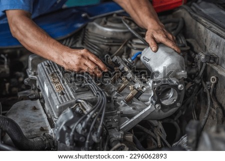 Engine repair and service in garage service shop. Royalty-Free Stock Photo #2296062893