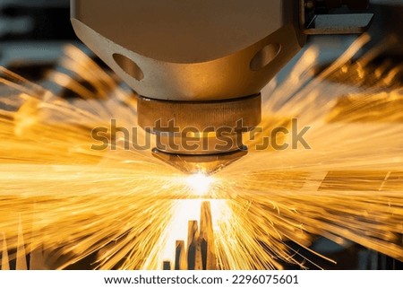 Close-up scene the fiber laser cutting machine cutting  machine cut the metal plate. The hi-technology sheet metal manufacturing process by laser cutting machine.  Royalty-Free Stock Photo #2296075601