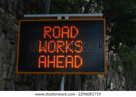 Road works ahead LED warning sign on city street. Royalty-Free Stock Photo #2296081719