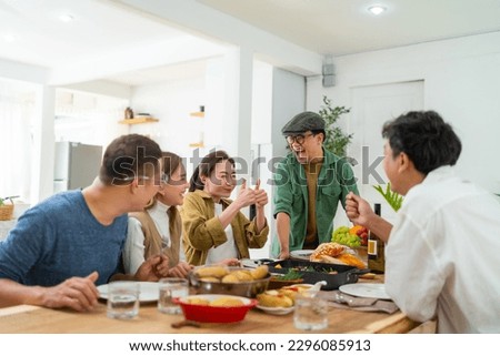Group of Happy Asian people enjoy and fun celebration dinner party sharing and eating food with drinking wine together at home. Cheerful man and woman friends reunion meeting event on holiday vacation