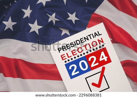 Politics and voting concept. Presidential election 2024 text on white paper over the American flag background Royalty-Free Stock Photo #2296088381