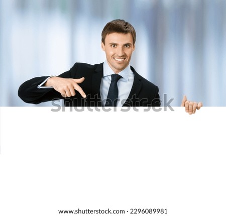 Image of business man professional bank manager confident black suit. Businessman stand behind, hang over, show point finger empty white banner signboard. Blurred office background.