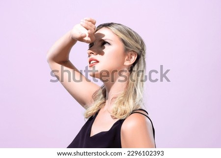 Closeup young blond hair woman with perfect skin and soft alluring facial makeup raise her hand cover her face from bright sunlight in pink isolated background for skincare sunscreen product. Royalty-Free Stock Photo #2296102393