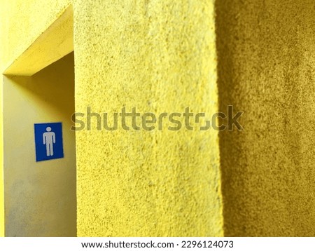 A yellow building of male toilet.