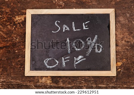 Sale word written  chalkboard on wooden background 