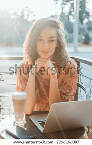 Young beauty girl working on laptop, happy face, outdoor hipster portrait on the cafe, smile happy face, listen music on headphones, Amsterdam street, dance, player,photo concept
