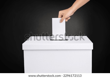 Filling in ballots and casting votes in booths at polling station. The concept of free democratic vote elections. Royalty-Free Stock Photo #2296172113