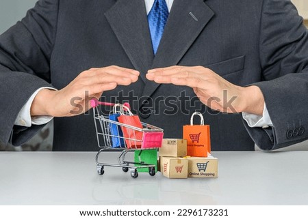 Consumer rights and consumer protection, business law concept : Buyer protects bags and boxes of goods purchased online from internet retailer's website, depicting the protection of items purchased. Royalty-Free Stock Photo #2296173231