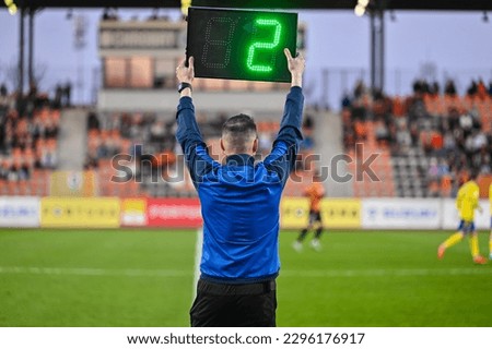 Sideline referee shows 2 minutes added time during the football match. Royalty-Free Stock Photo #2296176917