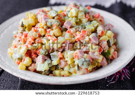Olivier salad, Christmas food on a dark chalkboard Royalty-Free Stock Photo #229618753