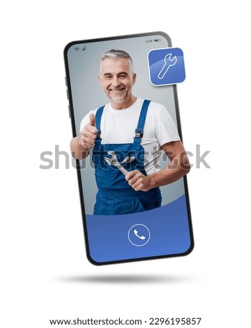 Plumber and repairman videocalling on smartphone and giving a thumbs up, hire a contractor online Royalty-Free Stock Photo #2296195857
