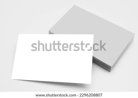 Business card stack template for brand identity separated, clipping path. Blank white business cards on gray paper background. Mockup for branding identity. Template for graphic designers portfolios.