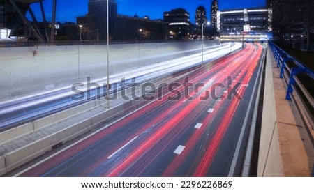High-speed traffic in the city. Expressway. Night cityscape. Blurred car lights. Photography for design and background