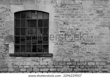 Black and white picture of an old decaying window photographed outside