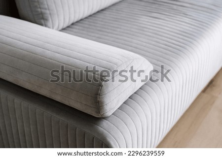 closeup of luxury couch with grey upholstery and comfortable armrest in store, repair and restoration furniture concept, dry cleaning service Royalty-Free Stock Photo #2296239559