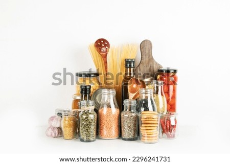 Food supplies crisis food stock. Different glass jars with grains, pasta, cans of canned food on  white background. 
