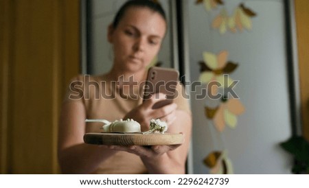 Young woman taking photos with tasty choco cake holding cake posing to camera