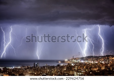 Night cityscape with strong lightning, majestic view on coastal town in dark stormy night, dramatic sky scape with bright zipper