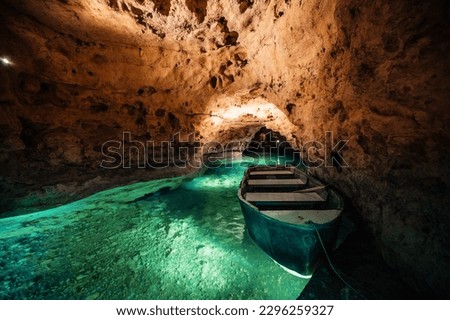 Underground Lake.. Cave of Tapolca, Hungary near Balaton lake. System of underground caves situated in the heart of the city. Boat trip Royalty-Free Stock Photo #2296259327