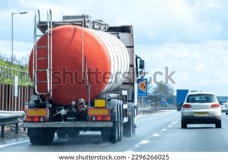 A fuel tanker traveling along a motorway in the United Kingdom