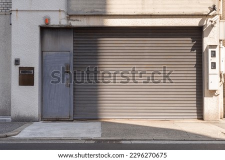 Automatic white roller shutter doors on the ground floor of the house Royalty-Free Stock Photo #2296270675