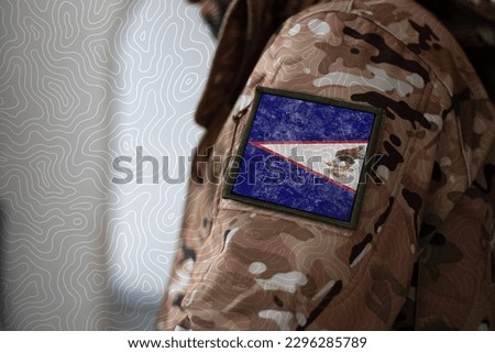 American Samoa Soldier. Soldier with flag American Samoa, American Samoa flag on a military uniform. Camouflage clothing