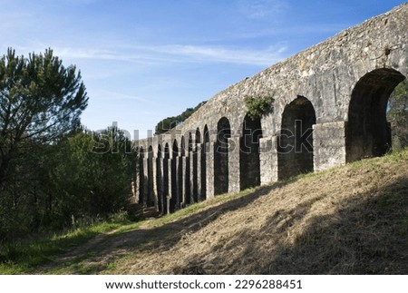 Wonderful landscapes in Portugal. Beautiful scenery of Aqueduct of the Convent of Christ in Tomar. It is 6 kilometres long with a total of 180 arches. Sunny spring day. Selective focus Royalty-Free Stock Photo #2296288451