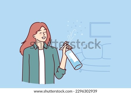 Woman uses air freshener to get rid of unpleasant smell in apartment after cleaning. Housewife girl stands in living room with air freshener spraying fragrance to create comfortable environment Royalty-Free Stock Photo #2296302939
