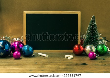 Christmas decoration, Santa and new blackboard on wooden wall  as a background for your message to holiday Christmas and celebration time.
