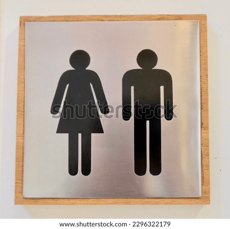 Toilet symbol, man and woman in wood flame.