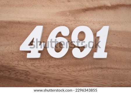 White number 4691 on a brown and light brown wooden background.