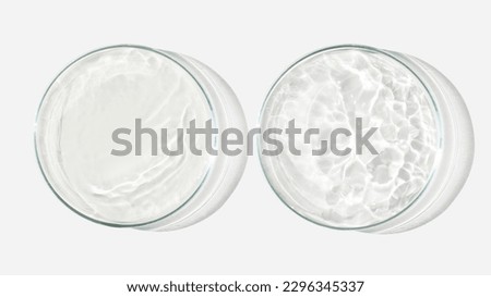 Two Petri dishes on a light background with liquid, water. Splashes of water. Waves in the petri dishes. View from above. Laboratory Royalty-Free Stock Photo #2296345337