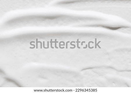 A smeared texture of white foam all over the background.